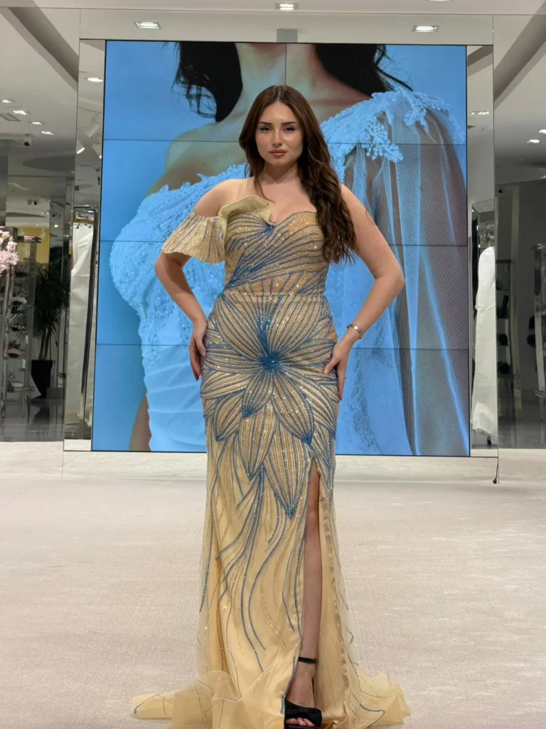 Model wearing a cream gown bodice in store.
