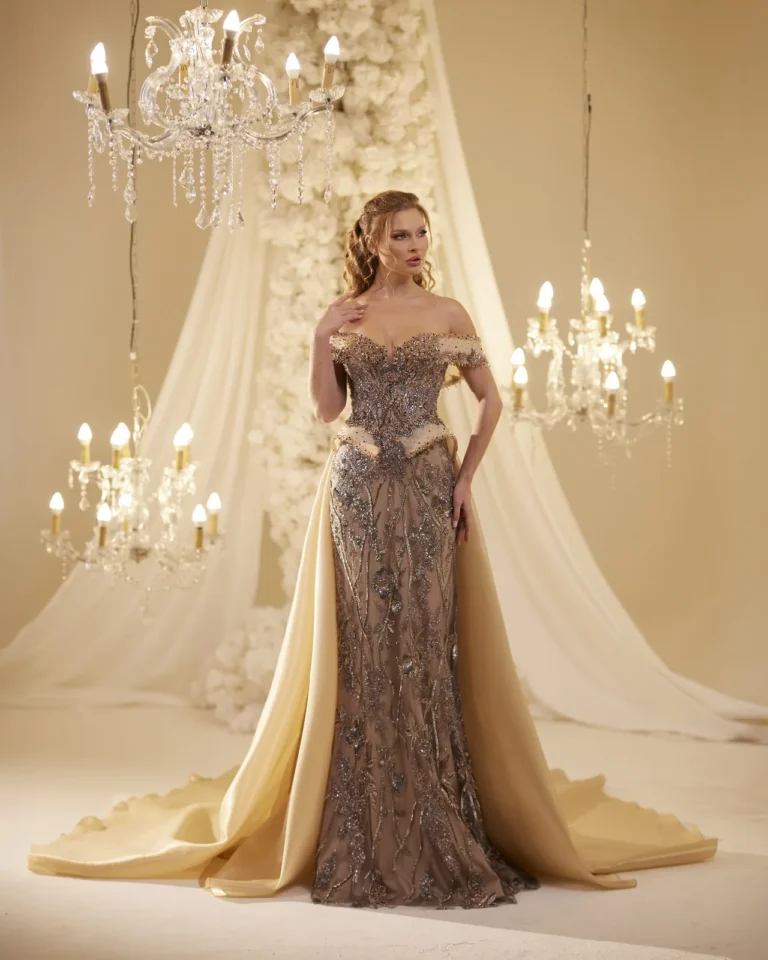 Model wearing a gold evening gown full skirt.