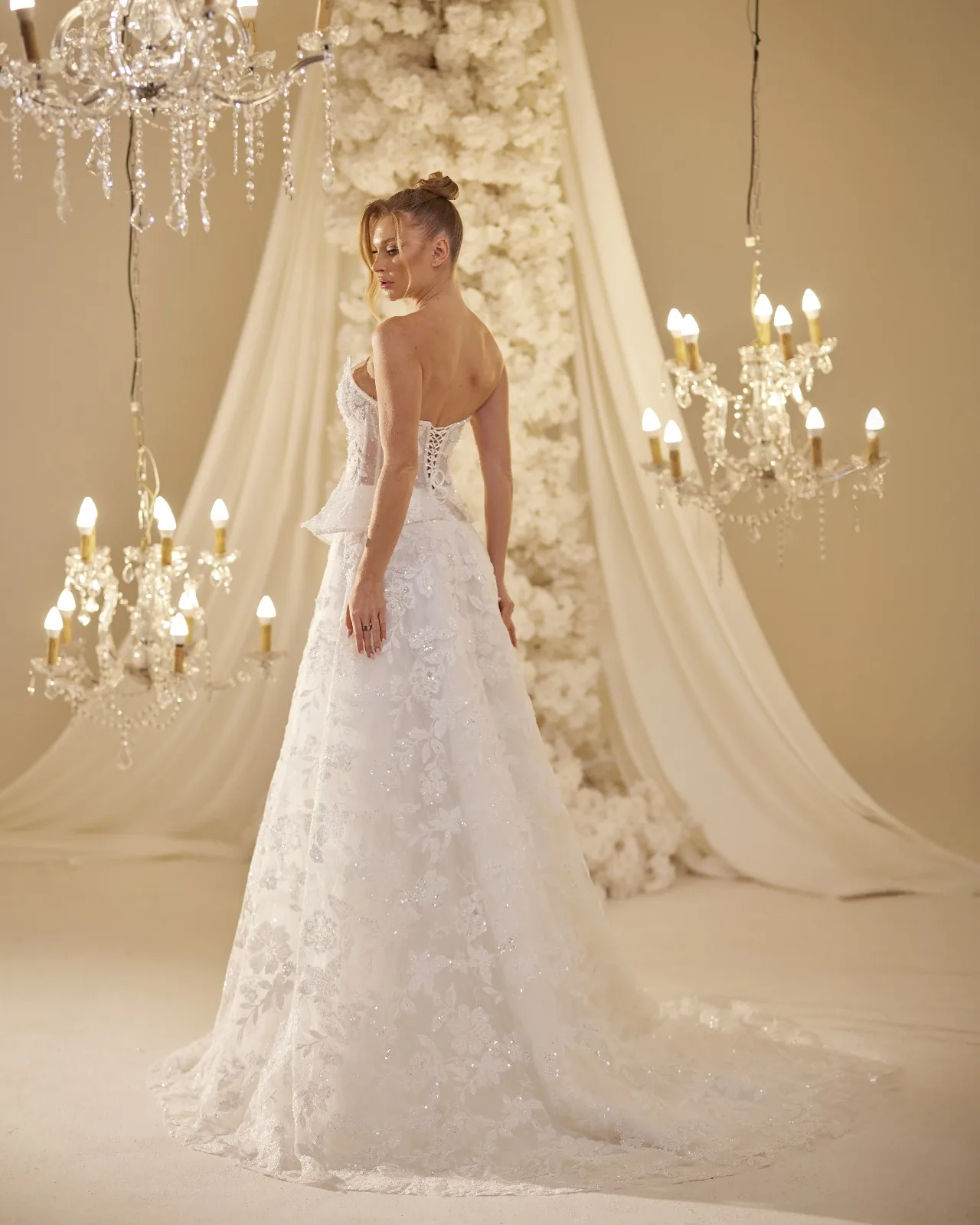 Back view of an ivory bridal gown with a long flowing train
