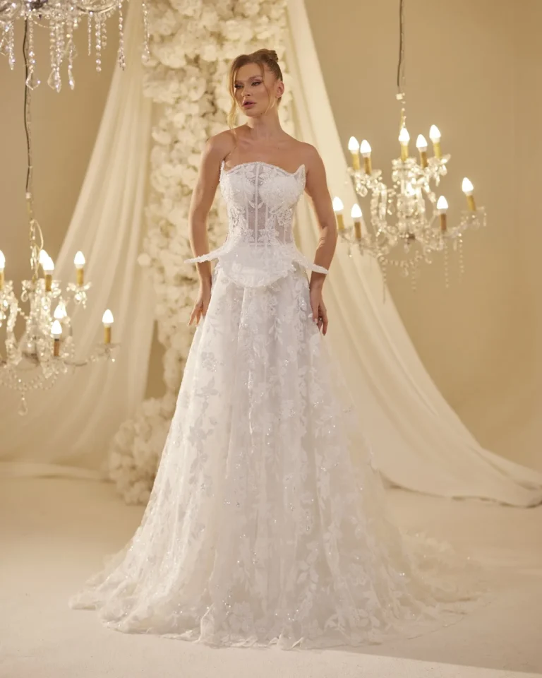 Model wearing a ivory bridal gown flowing skirt.