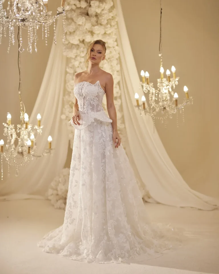 Model wearing a ivory bridal gown front train.