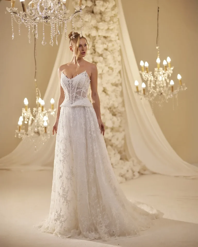 Model wearing a ivory bridal gown full length.