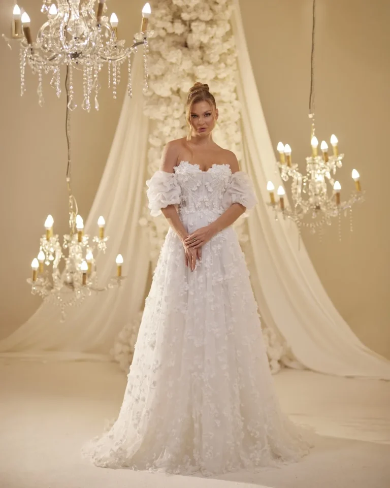 Model wearing a ivory bridal gown full length front.