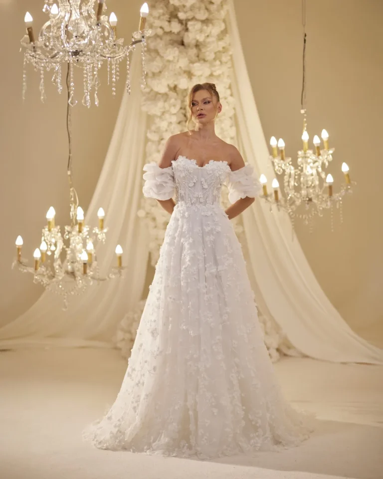 Model wearing a ivory bridal gown full skirt.