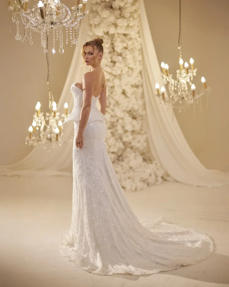 Model wearing a ivory bridal gown rear view.