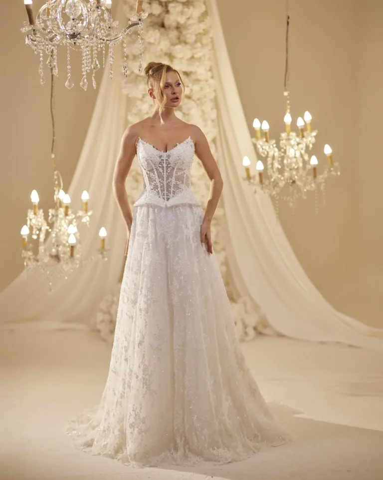 Model wearing a ivory bridal gown side profile.
