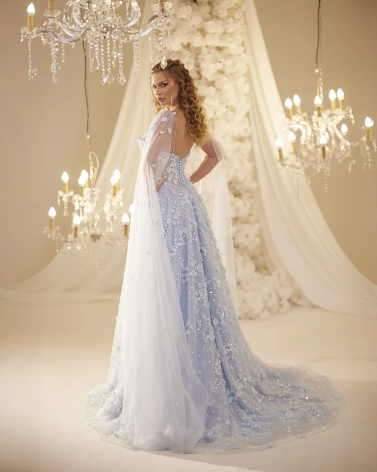 Model wearing a light blue evening gown side view.