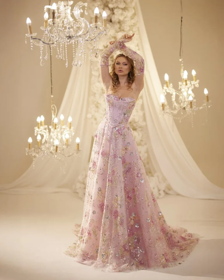 Model wearing a pink evening gown flowing skirt.