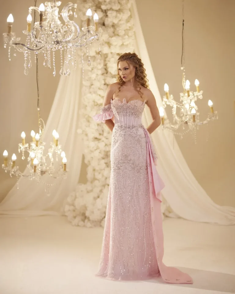 Model wearing a pink evening gown full length front.
