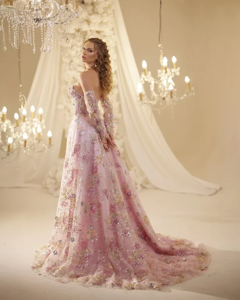 Model wearing a pink evening gown side view.