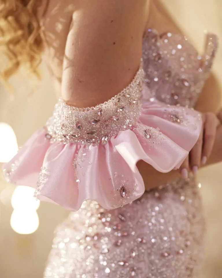 Model wearing a pink gown back bow detail.