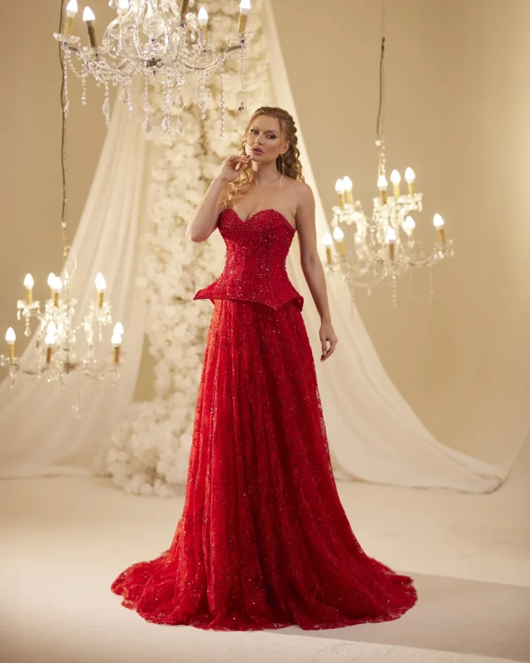 Model wearing a red evening gown side profile.