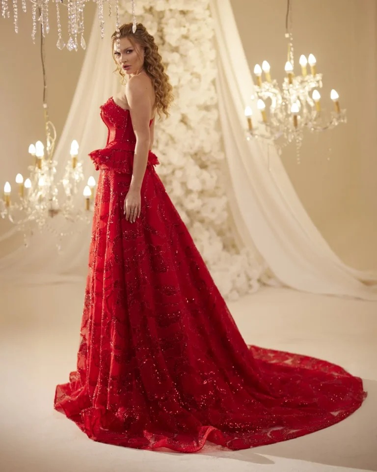 Model wearing a red evening gown side view.