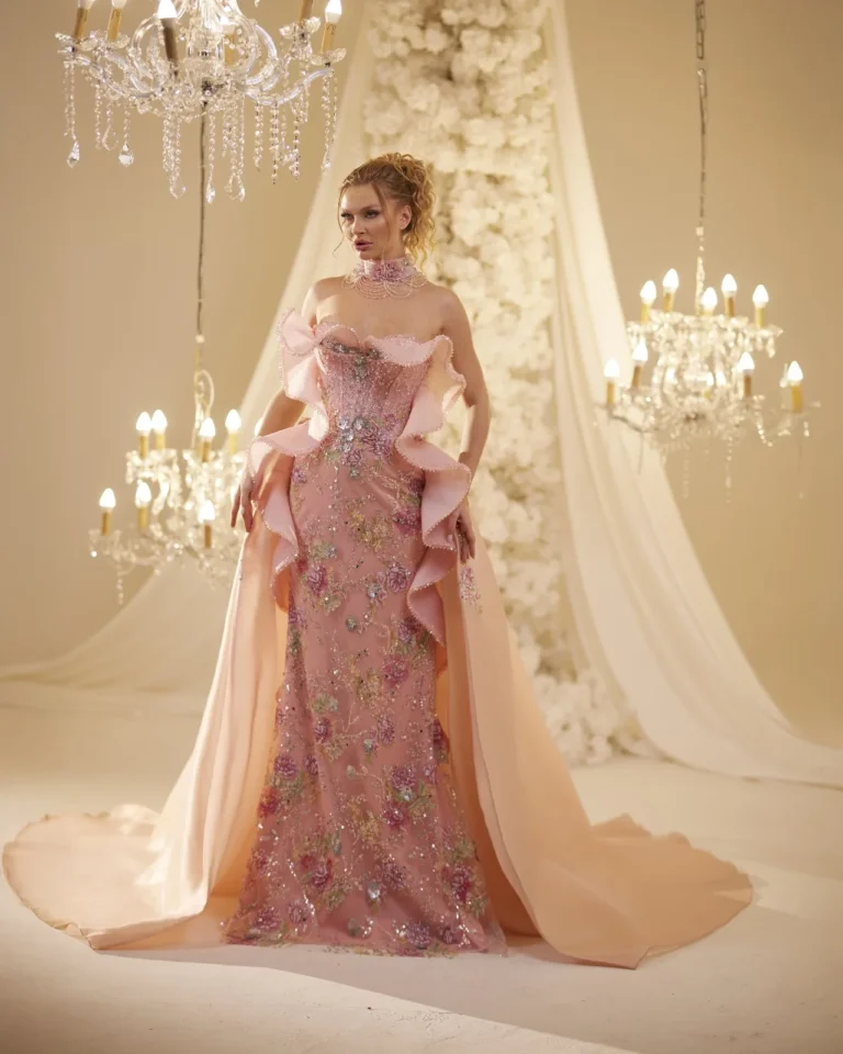 Model wearing a rose evening gown side view.