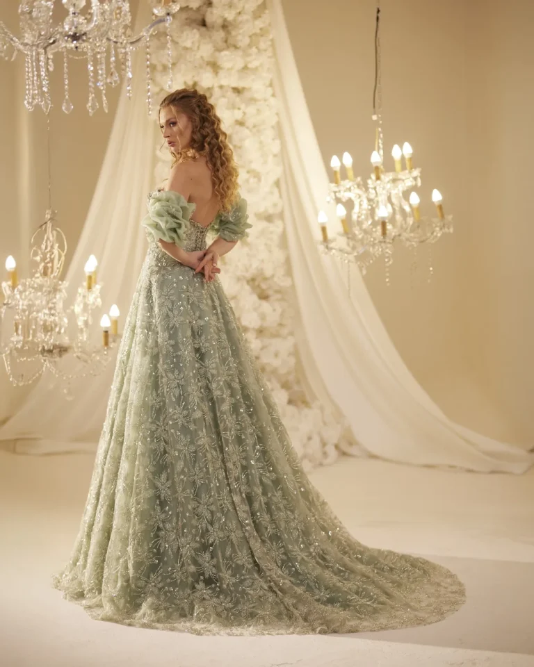 Model wearing a sage green evening gown back.