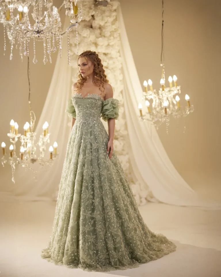Model wearing a sage green evening gown side view.