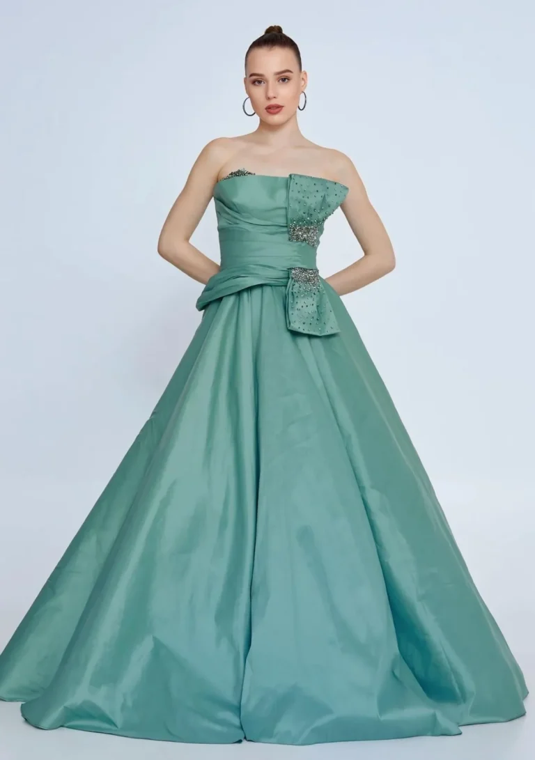Model wearing a sage green full skirt gown.