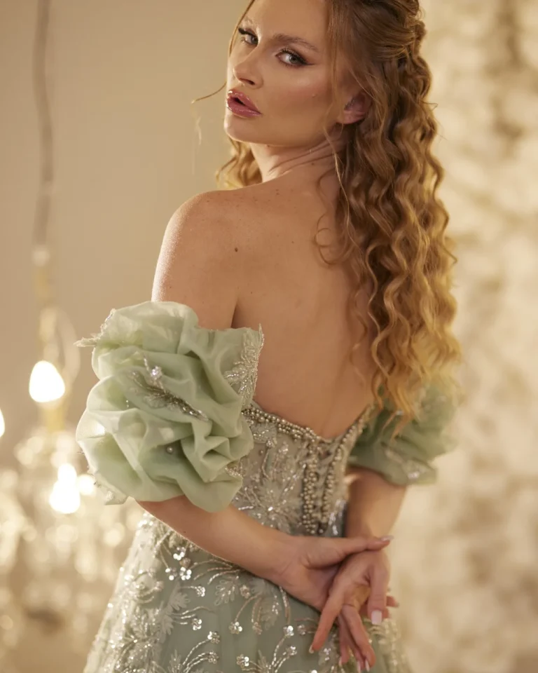Model wearing a sage green gown bodice detail.